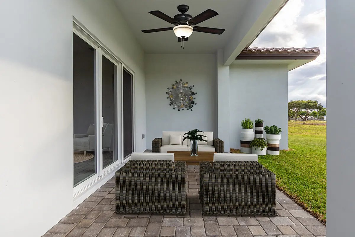 A patio with furniture and a ceiling fan.