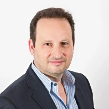 Man in suit with white background.