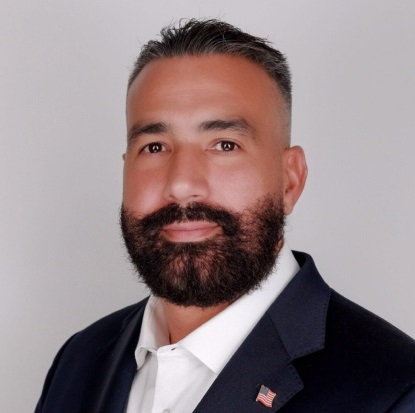Man in suit with American flag pin.