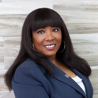 Smiling woman in a professional suit.