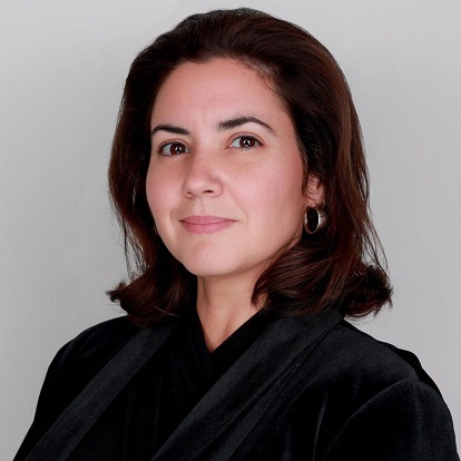 Woman in black attire, neutral expression.