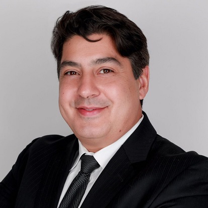 Smiling man in a suit and tie.