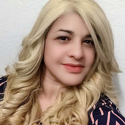 Woman with long blonde curly hair.