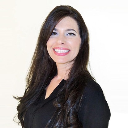 Smiling woman with long dark hair.