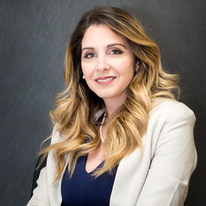 Woman smiling in formal attire, professional portrait.