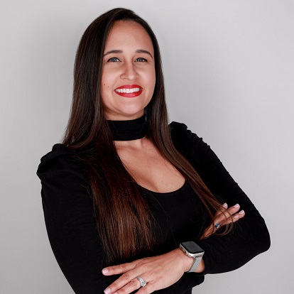 Smiling woman in black with long hair.